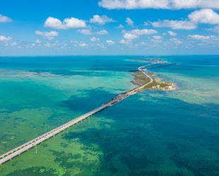 Drone point of view shot of a bridge and islands in the sea under a blue sunny sky, Key West, Florida, USA